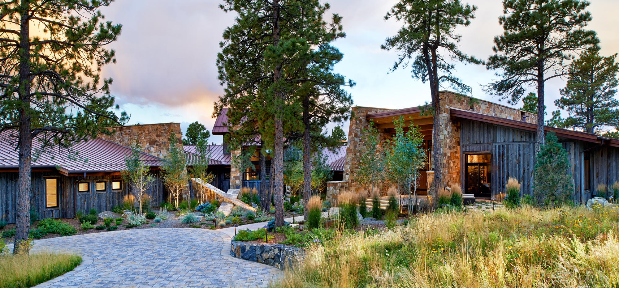 Home of the year pictured in its mountain setting with large douglass firs