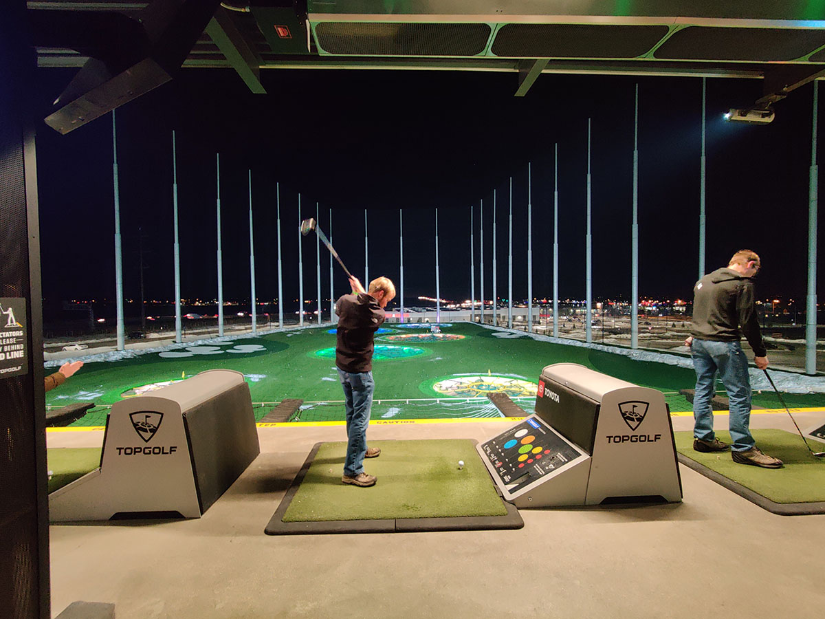 Team member playing golf at Topgolf