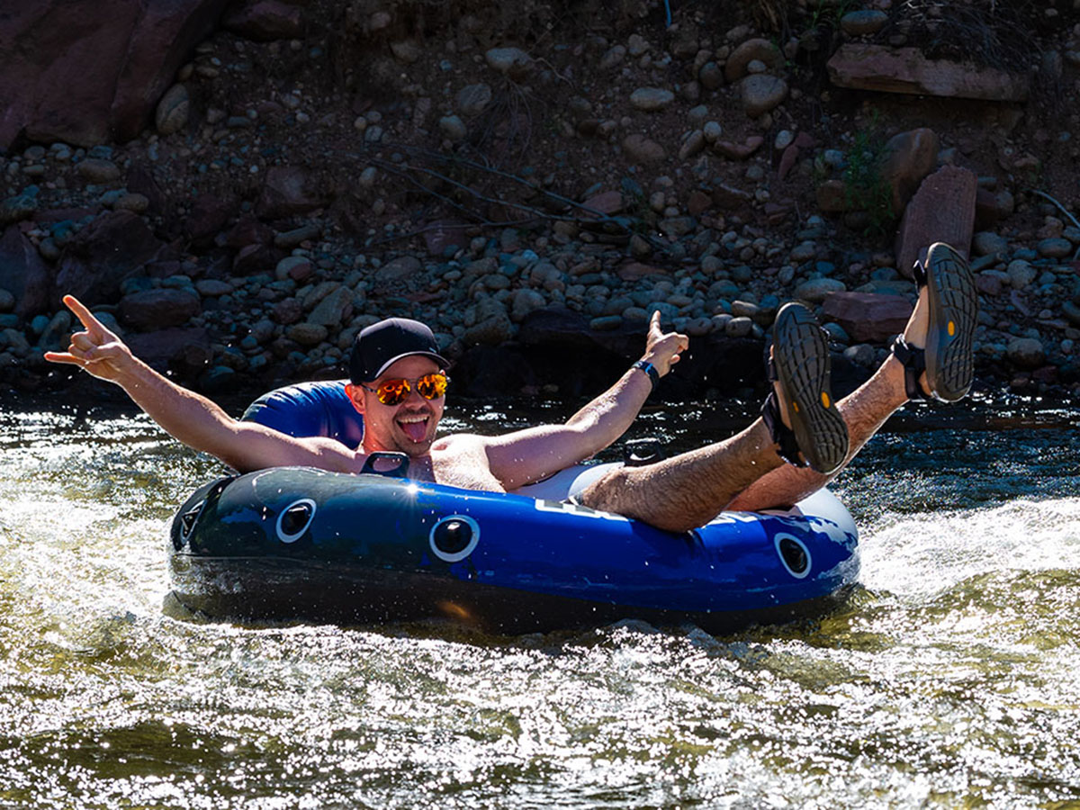 Team member tubing down the river
